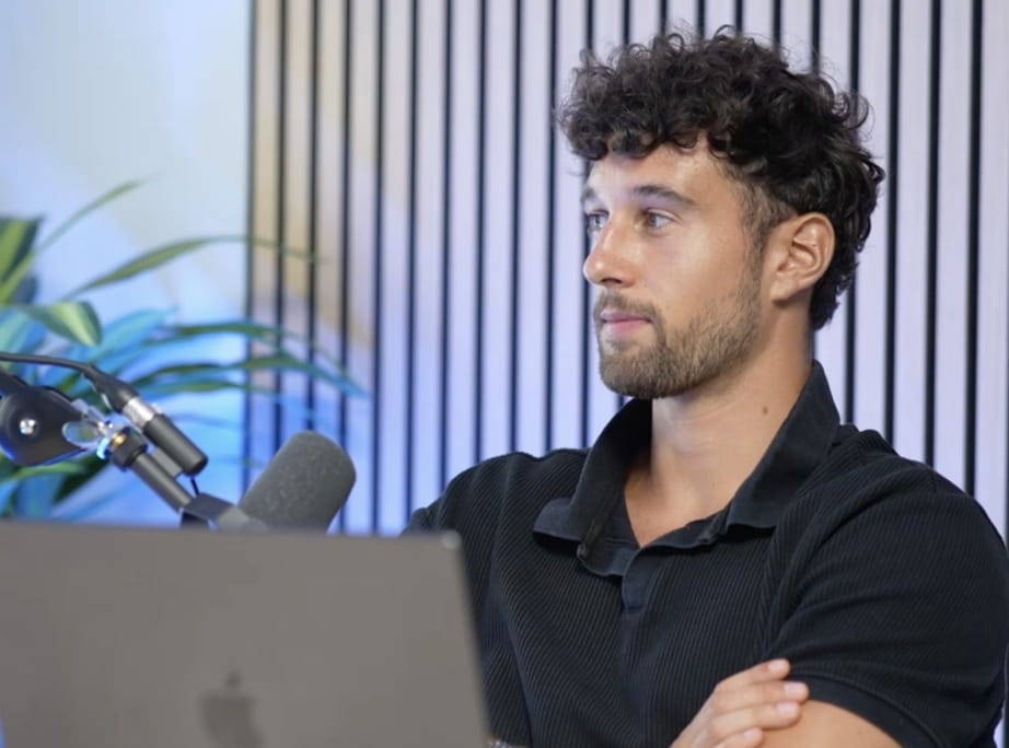 Intervenant en polo noir de profil pendant une interview filmée en studio